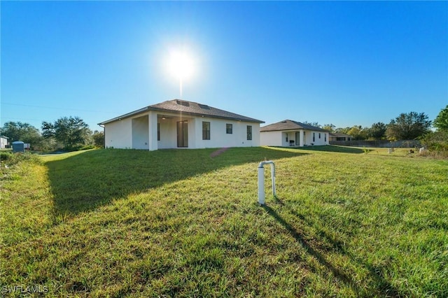 rear view of house with a yard