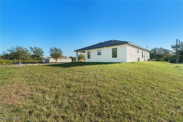 view of side of home with a yard