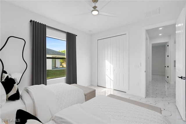 bedroom with ceiling fan and a closet