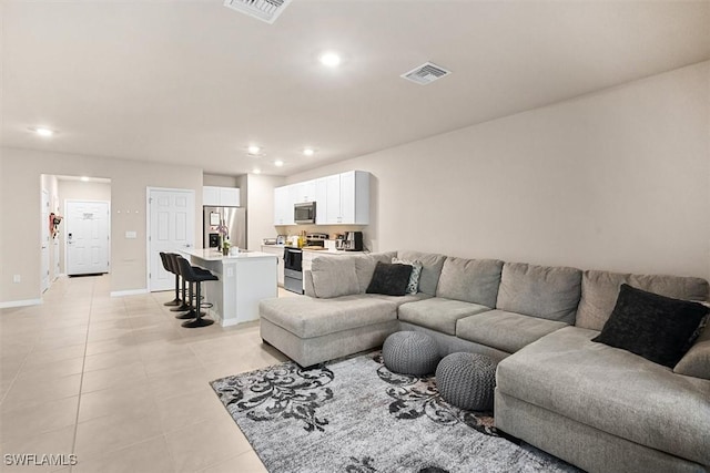 living room with light tile patterned flooring