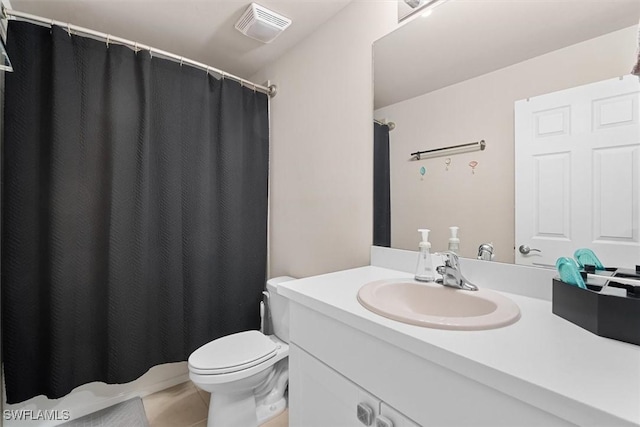 bathroom featuring vanity, toilet, and tile patterned flooring