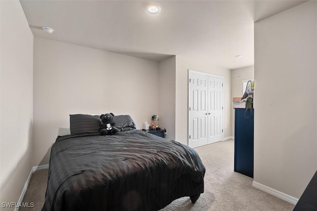 bedroom featuring a closet and light carpet