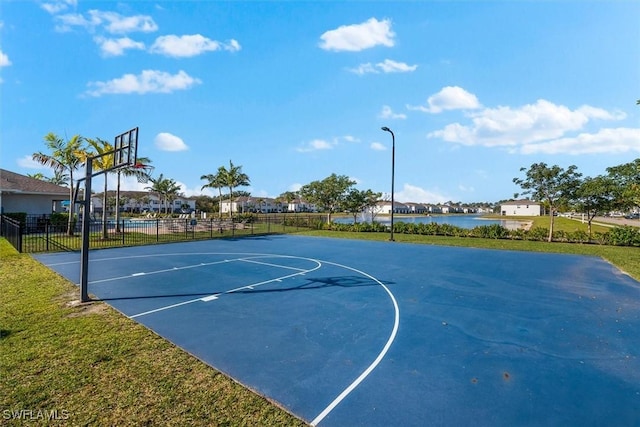 view of sport court with a water view