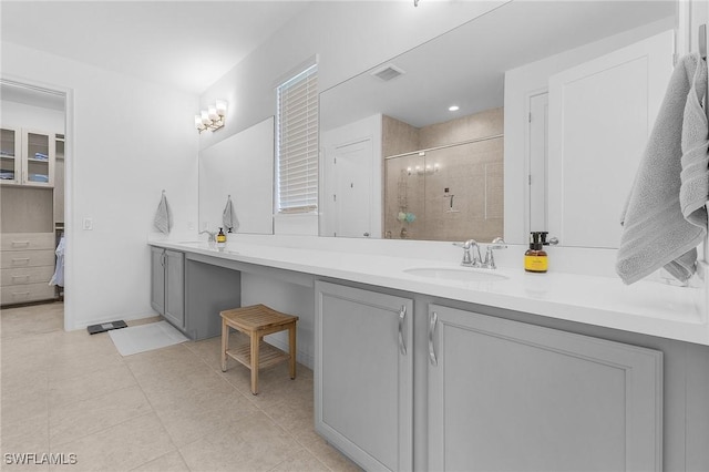 bathroom featuring vanity, tile patterned floors, and walk in shower