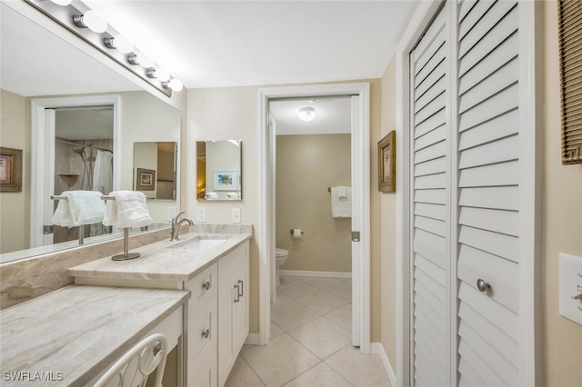 bathroom with vanity, tile patterned floors, and toilet