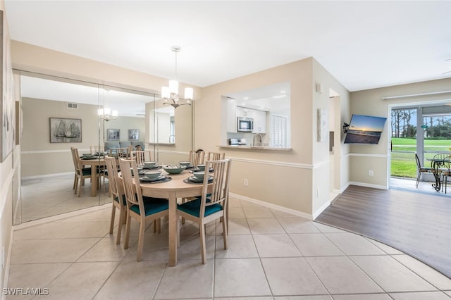 dining room featuring a chandelier, sink, and light tile patterned floors