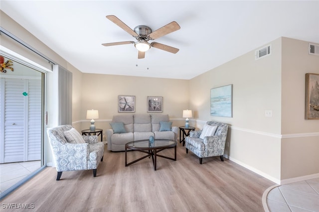 living room with ceiling fan and light hardwood / wood-style floors