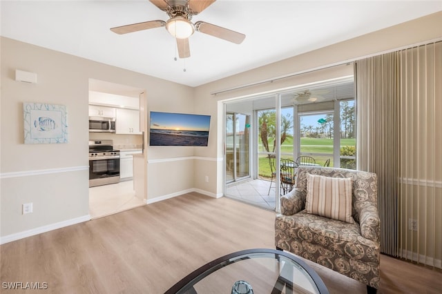 sitting room featuring ceiling fan and light hardwood / wood-style floors