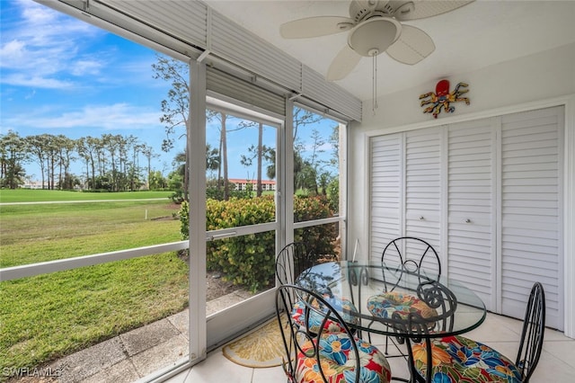 sunroom / solarium featuring ceiling fan