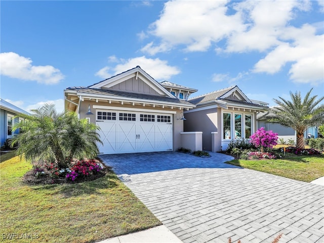 view of front of home featuring a garage and a front lawn