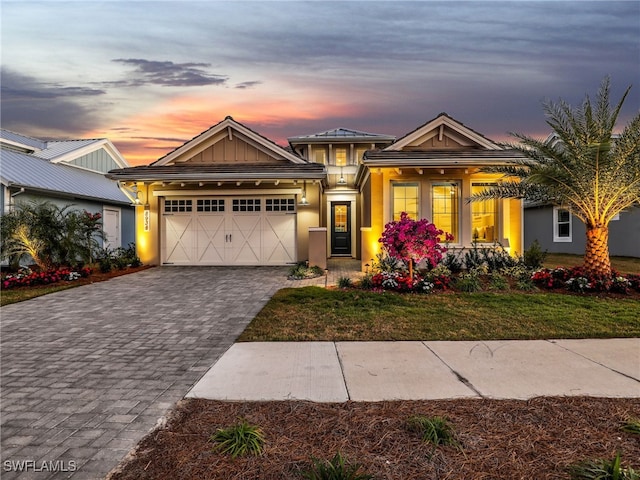 view of front of property with a garage and a yard