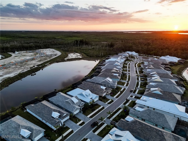 aerial view at dusk with a water view