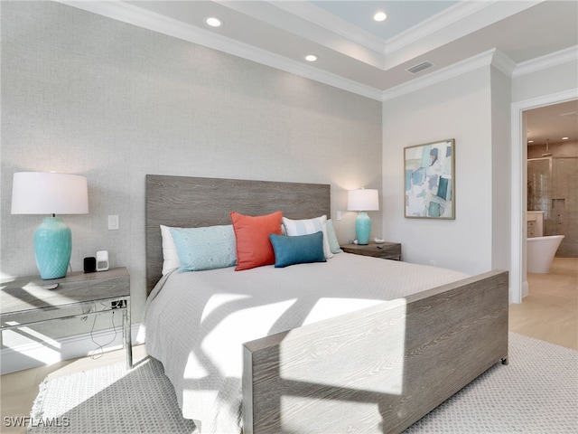 bedroom with crown molding and ensuite bath