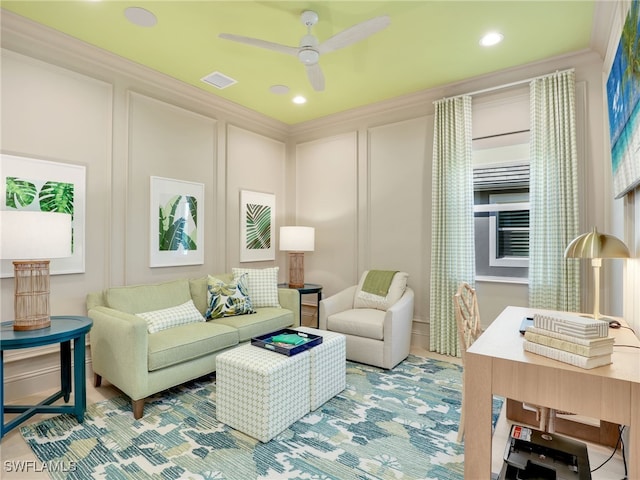 living room featuring ceiling fan and ornamental molding