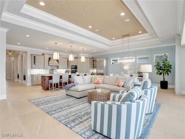 living room featuring ornamental molding and a raised ceiling