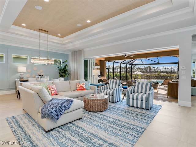 living room featuring ornamental molding, a raised ceiling, ceiling fan, and light tile patterned flooring