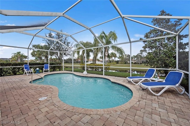 view of swimming pool with a water view, a lanai, and a patio area