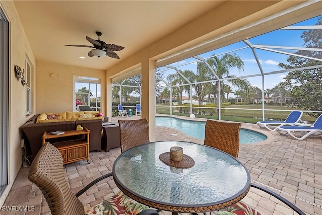 view of patio with a lanai, an outdoor hangout area, and ceiling fan