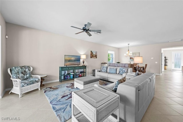 living room with ceiling fan with notable chandelier and light tile patterned flooring