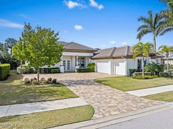 view of front of home featuring a garage and a front yard