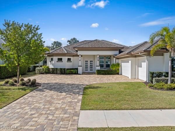 view of front of home featuring a garage and a front lawn