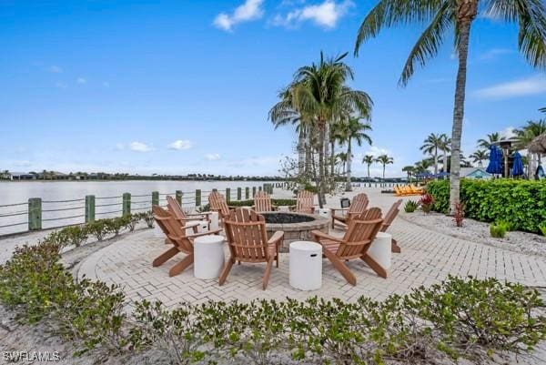 view of patio with a water view and an outdoor fire pit