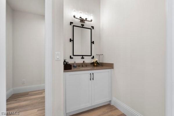 bathroom with vanity and wood-type flooring