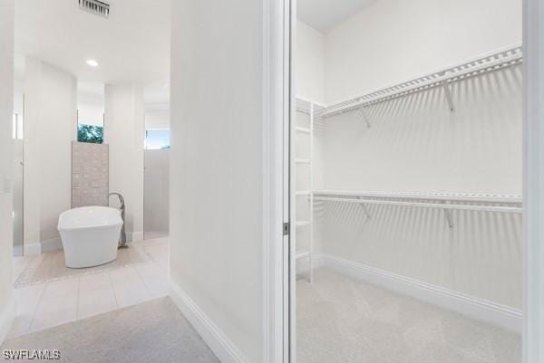 bathroom featuring tile patterned flooring and a washtub