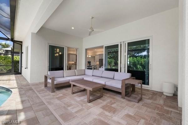 view of patio featuring outdoor lounge area, ceiling fan, and a lanai