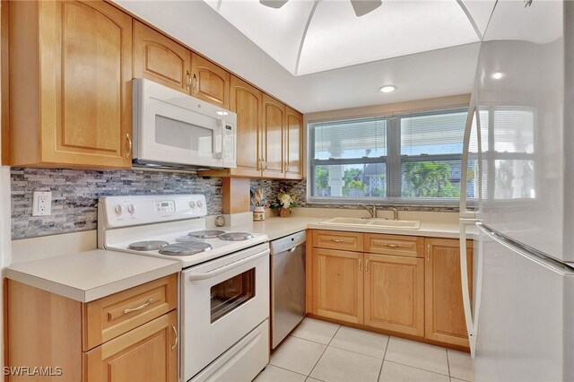 kitchen featuring sink, white appliances, light tile patterned floors, ceiling fan, and decorative backsplash