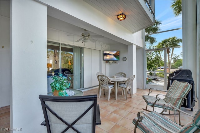 view of patio with a lanai, ceiling fan, and outdoor dining space