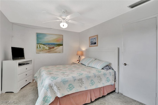 bedroom with ceiling fan and light colored carpet