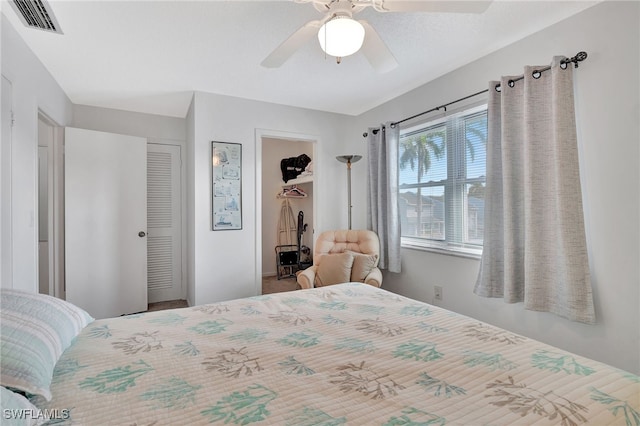 bedroom with ceiling fan and a closet