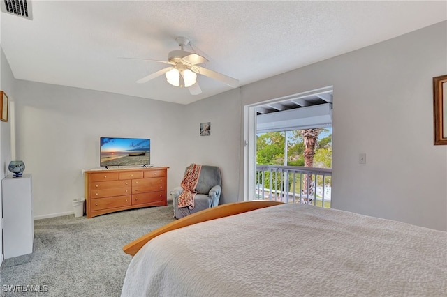 bedroom with ceiling fan, light carpet, and a textured ceiling