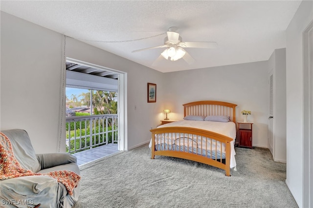 bedroom with a textured ceiling, light colored carpet, access to exterior, and ceiling fan