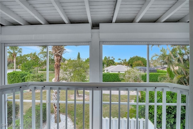 unfurnished sunroom featuring beamed ceiling and wooden ceiling