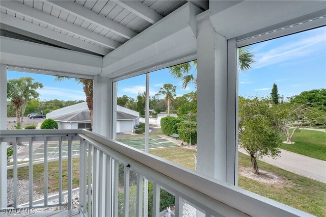 sunroom / solarium featuring beam ceiling and wooden ceiling