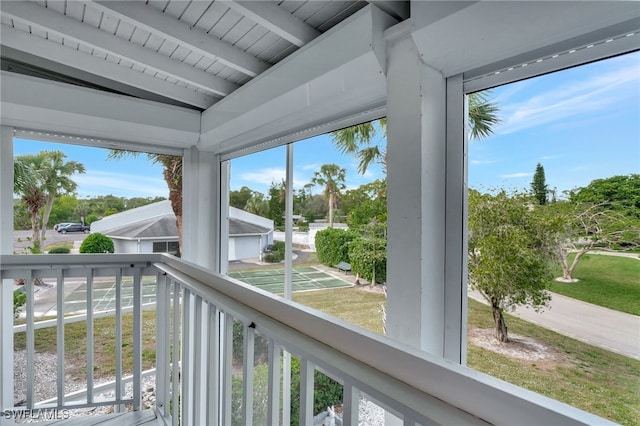 sunroom / solarium featuring beamed ceiling and wooden ceiling