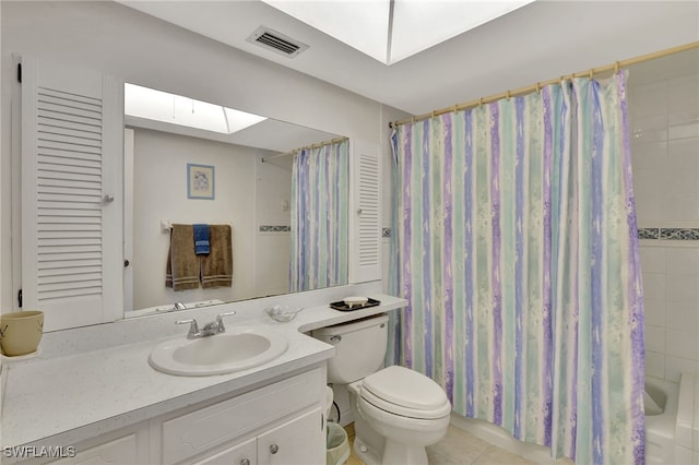 full bathroom with shower / bath combo, tile patterned flooring, a skylight, vanity, and toilet