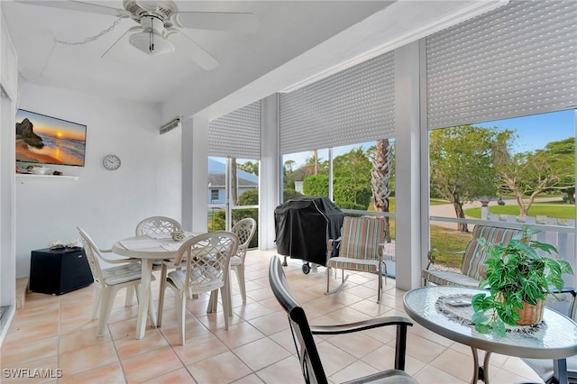 sunroom / solarium featuring ceiling fan