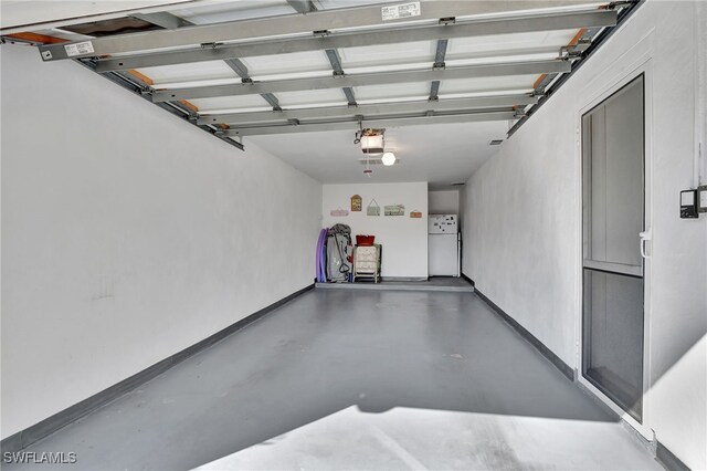 garage featuring a garage door opener and white fridge