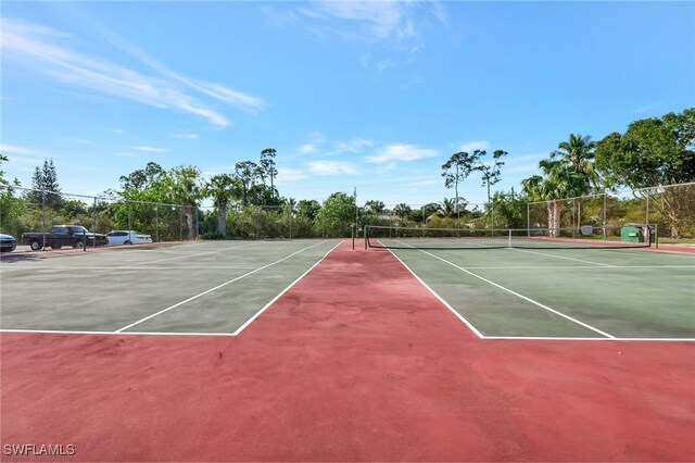 view of sport court featuring fence