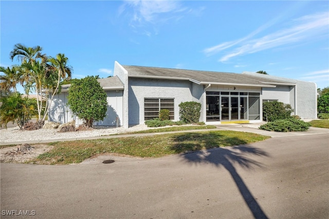 mid-century inspired home featuring stucco siding