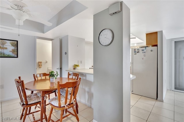 dining area with light tile patterned flooring and a ceiling fan