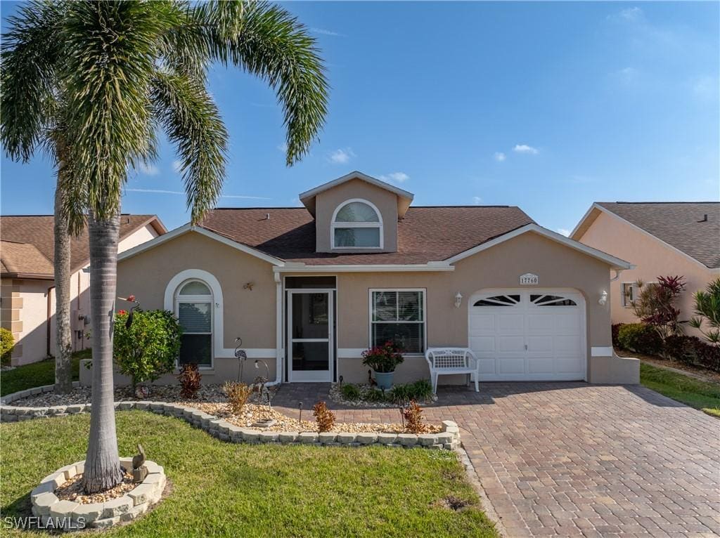 view of front of property featuring a garage and a front yard