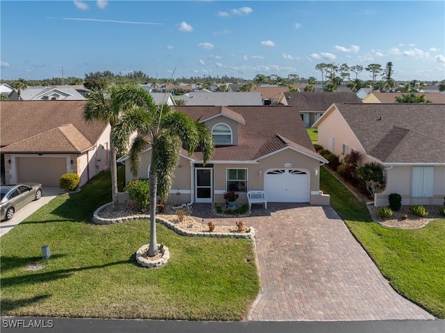 view of front of home featuring a garage and a front lawn