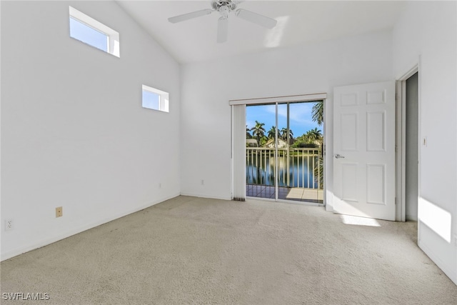 1040 Partridge Cir Unit 201, Naples, FL 34104 - carpeted empty room featuring a water view, a healthy amount of sunlight, and ceiling fan