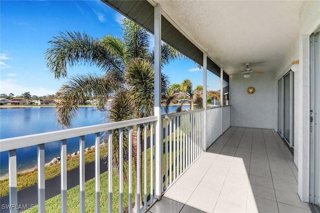 balcony featuring a water view and ceiling fan