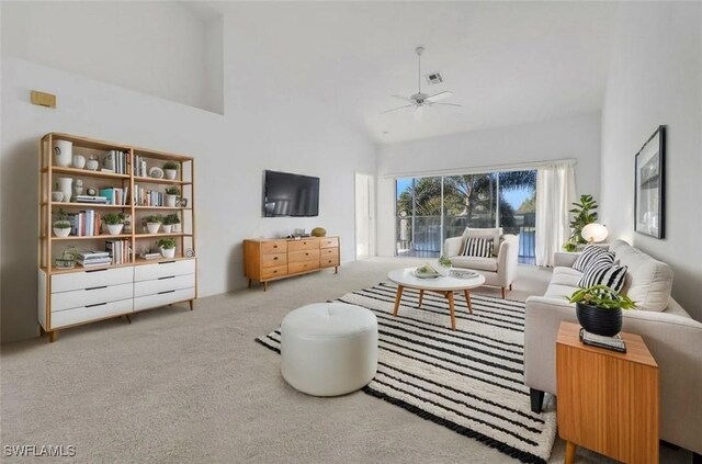 1040 Partridge Cir Unit 201, Naples, FL 34104 - living room featuring ceiling fan, carpet floors, and high vaulted ceiling