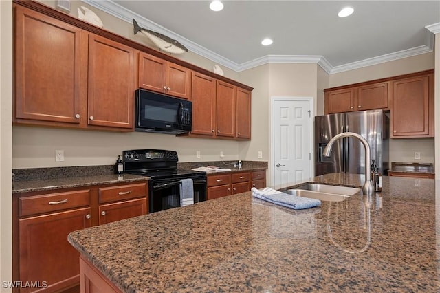 kitchen with sink, ornamental molding, dark stone counters, a kitchen island with sink, and black appliances